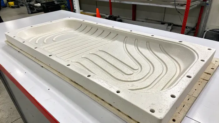 A close-up of a plastic part with visible flow lines.