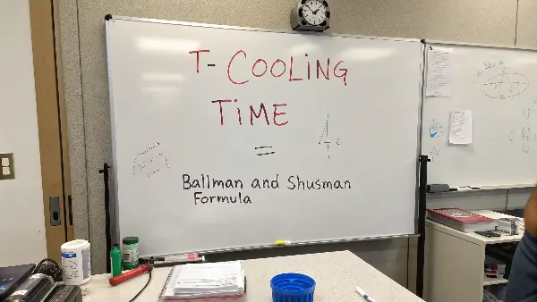 The Formula for Injection Mold Cooling Time A whiteboard with the cooling time formula written out, with each variable clearly labeled.