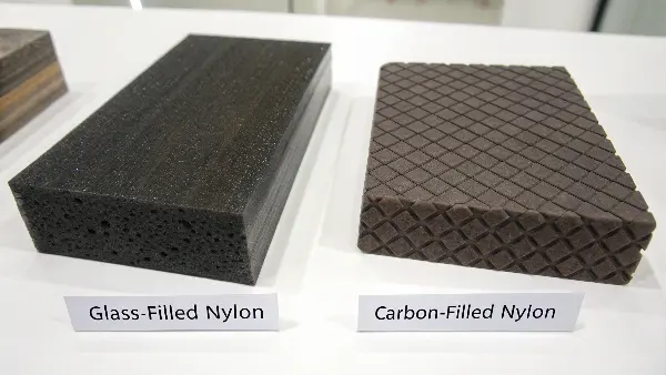 A close-up comparison of glass-filled and carbon-filled nylon pellets